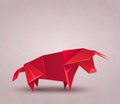 Red origami bull made of paper on Chinese background. The symbol of the Eastern New Year. Polygonal figure of livestock. Strong