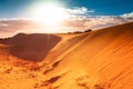 Red sand dune with ripple and blue sky Royalty Free Stock Photo