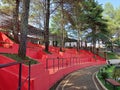 Red outdoor tiered seating area in a pine forest park Royalty Free Stock Photo