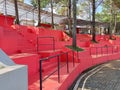 Red outdoor tiered seating area in a pine forest park Royalty Free Stock Photo