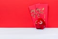 Red Ox Piggy Bank and Red Envelope With Chinese Script Happy Chinese New Year