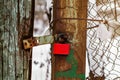 Red padlock on a broken poor gate Royalty Free Stock Photo