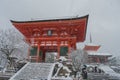 Red Pagoda at Kiyomizu-dera temple with tree covered white snow background.