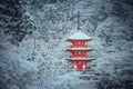 Red Pagoda at Kiyomizu-dera temple with tree covered white snow background.