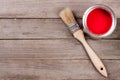 Red paint in the bank to repair and brush on the old wooden background with copy space for your text. Top view Royalty Free Stock Photo