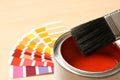 Red paint can, brush and color palette on table, closeup. Space for text Royalty Free Stock Photo