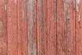 Red paint peeling off of old wooden boards on the side of a barn texture Royalty Free Stock Photo