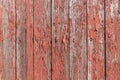 Red paint peeling off of old wooden boards on the side of a barn texture Royalty Free Stock Photo