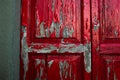 Red paint peeling off an old wooden door. Royalty Free Stock Photo