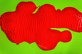 Red paint smear on green background Royalty Free Stock Photo