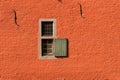 Two small windows in a red brick wall Royalty Free Stock Photo