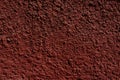 Red painted cement plaster pimpled wall surface