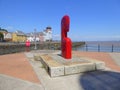 Red painted sculpture at harbour entrance