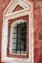 Russia, Rostov, July 2020. Small window in the red wall of the old church. Royalty Free Stock Photo