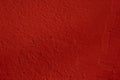 Red painted wall. Bright textured background. Vibrant close-up.