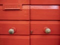 Red painted wood door with a mail box Royalty Free Stock Photo