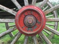 red painted wooden wheel axle with bolt + nut of an old car detail Royalty Free Stock Photo