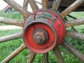 Red painted wooden wheel axle with bolt + nut of an old car Royalty Free Stock Photo