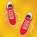 Red pair of sneakers with white laces.