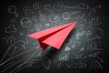 A red paper airplane among doodles symbolizes innovation, creativity, and forward thinking on white background Royalty Free Stock Photo