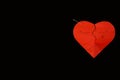 Red paper broken heart on black background with pin. Royalty Free Stock Photo