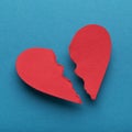 Red paper broken heart on bright blue background Royalty Free Stock Photo