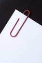 Red paper clip and paper Royalty Free Stock Photo