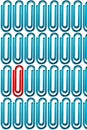 Red paper clip standing out from the crowd of blue paper clips over white background Royalty Free Stock Photo