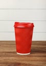 Red paper coffee cup over white wall Royalty Free Stock Photo