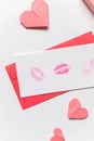 Red paper envelope with white blanks with lipstick kisses and origami hearts. Valentine\'s day concept card. Royalty Free Stock Photo