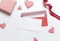 Red paper envelope with white blanks and pink origami hearts. Valentine\'s day concept card. Royalty Free Stock Photo