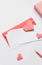 Red paper envelope with white blanks and pink origami hearts. Valentine\'s day concept card. Royalty Free Stock Photo