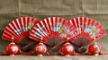 red paper fans with oriental writing on them are sitting next to a lamp Royalty Free Stock Photo