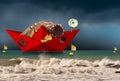 Red paper fishing boat with fishing nets in a rough sea Royalty Free Stock Photo