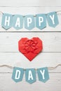 Red paper folded origami heart, happy love day banner garland nice inscription on white barn wood planks background. St.