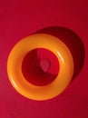 Red paper heart n plastic orange ring, circle on red background