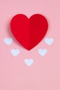 Red paper heart on the pink background. Valentine`s or Wedding`s day postcard concept.