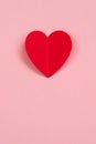 Red paper heart on the pink background. Valentine`s or Wedding`s day postcard concept.