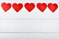 Red paper hearts garland on white wooden background, copy space for text. Greeting card mockup for Valentines Day. Love Royalty Free Stock Photo