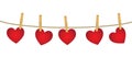 Red paper hearts hanging on clothesline