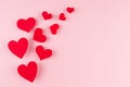 Red paper hearts soar on pink color background, copy space. Valentines day backdrop. Royalty Free Stock Photo