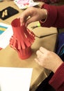 Red Paper lantern craft being show by grandma hands