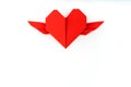 Red paper origami heart with wings on white background . Royalty Free Stock Photo