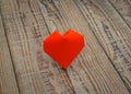 Red paper origami heart on wood background . Royalty Free Stock Photo