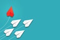 Red paper plane flying in a different direction than the white ones. Blue background. Copy space. The concept of innovative Royalty Free Stock Photo