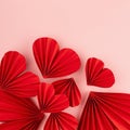 Red paper ribbed hearts fly on soft light pink background as festive Valentine day background, top view, copy space, square. Royalty Free Stock Photo