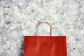 Red paper shopping bag on gray canvas background. Copy space for text Royalty Free Stock Photo