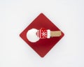 Red paper tag with a little christmas mitten pin