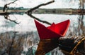 Red paperboat in a beautiful lake