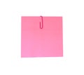 A red paperclip with blank pink notepaper. Pink sheet for your message or adding more text. Memo note with paper clip Royalty Free Stock Photo